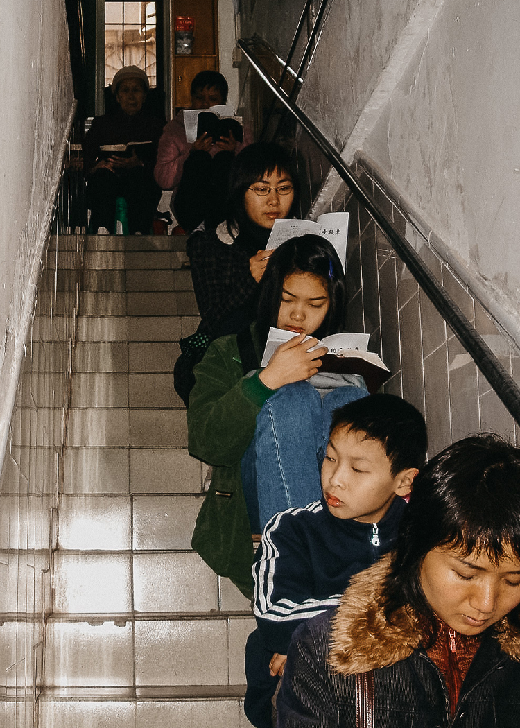 Group of Chinese believers sitting on stairwell
