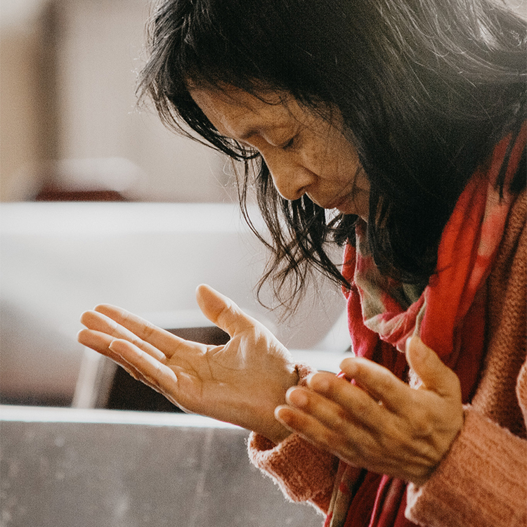 Chinese believer, wearing a red scarf, worshipping